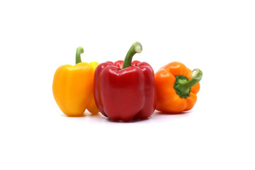 yellow and orange and red paprika isolated on white background