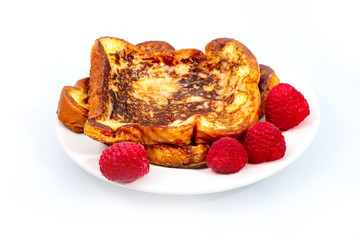 Delicious french toast with butter and raspberries, isolated on white