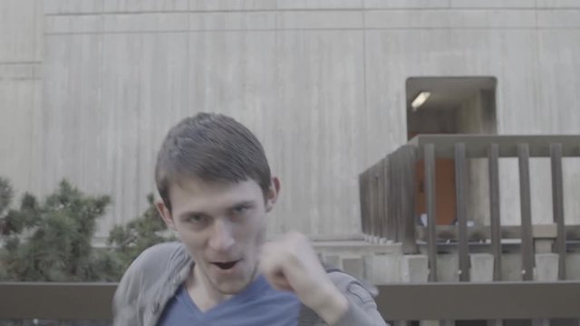 College boy man does Bruce Lee impression fight choreography