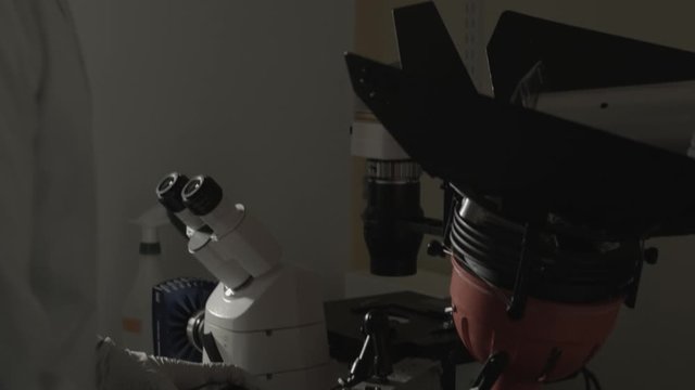 Scientist man cranking fixing science fiction contraption device invention gun technology by hand