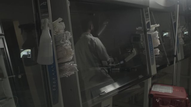 Scientist doctor man walks through lab with futuristic device contraption technology invention