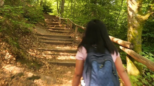 Young Woman walking up Stairs on a Hiking Trail in the Palatinate Forest, Germany