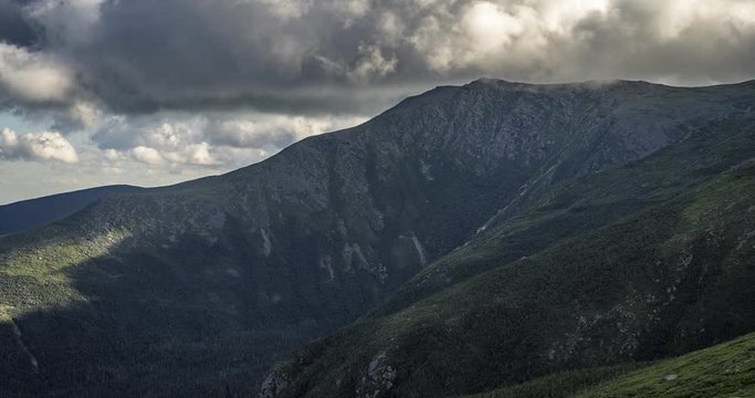 Time lapse midway up mount Washington in New Hampshire USA. Facing up at the mountain while clouds fly past. Includes 2 versions, one tilting down and 1 stationary.