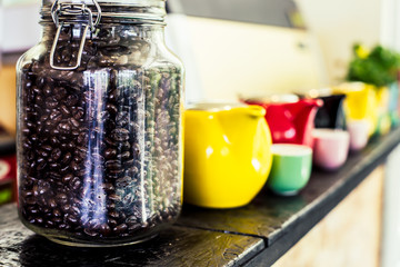 The coffee beans in bottles placed on shelves.