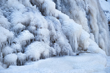 Icy waterfall on a mountain river.