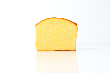 A piece of sliced butter cake isolated on white background,sweet bakery. Cut soft delicious pastry