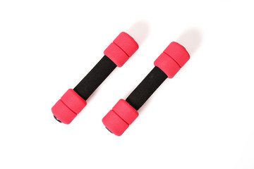 Soft dumbbells in black and pink sponge isolated on white background, bodybuilding equipment with light weight for woman. Physical exercise and aerobics activity, sport and object concept.