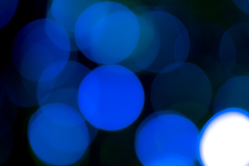 Natural blue bokeh, soft color tone, black surface.