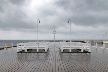 Empty Sopot pier in a cloudy, rainy day