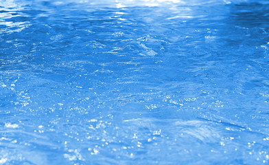 Obraz premium Water in swimming pool rippled water detail background. Vintage Water bokeh background. Bokeh blue, boke, background pattern.