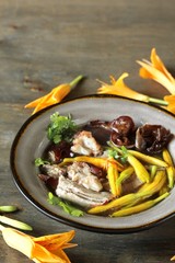 Asian soup with daylily flowers (golden needles), woody ear mushrooms and pork. Chinese cuisine. young daylily buds, edible flowers, foraging. daylily recipe