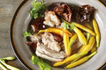 Asian soup with daylily flowers (golden needles), woody ear mushrooms and pork. Chinese cuisine. daylily recipe