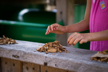 girl making piles of bark