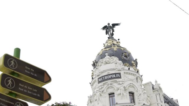 Slow motion: Madrid Metropolis building and street signs