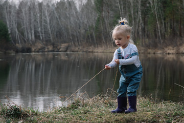 Little girl catches and feeds fish