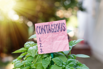 Conceptual hand writing showing Contagious. Concept meaning transmissible by direct or indirect...