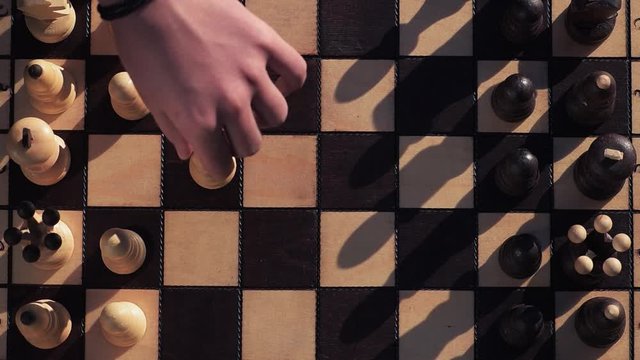 chess game close-up, players make the first moves in the game, top view
