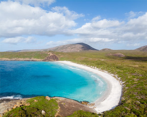 The beautiful Hellfire Bay in Esperance, Western Australia. Crystal clear blue water surrounds the beach with the national park in the background. 