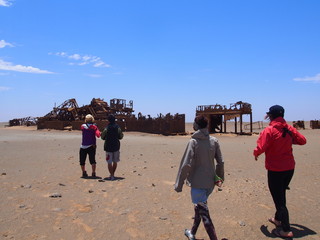 Derelict building and people in the desert, Skeleton Coast, Swakopmund, Namibia