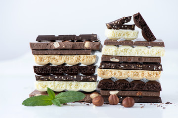 Different kinds of chocolates with nuts cocoa powder and mint