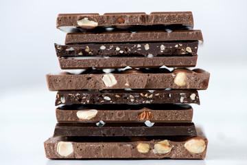 Different kinds of chocolates with nuts cocoa powder and mint