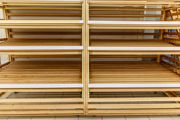 Empty wooden bread counters in a supermarket. Front view. Space for tech...