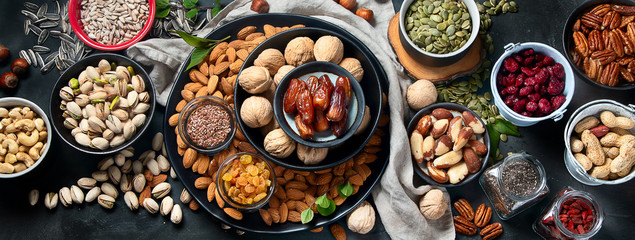 Different types of nuts, seeds and dried fruits - obrazy, fototapety, plakaty