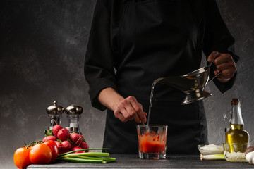 Cooking tomato sauce for a dish. Pouring water, freezing in motion. Cooking and recipe book.