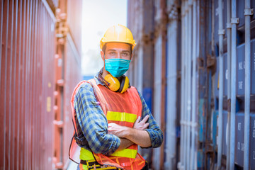 Portrait man dock worker under inspection and checking production process on dock station with radio communication by wearing safety mask to protect for pollution and virus in factory.