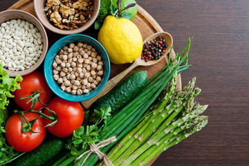 Organic fruits, vegetables, legumes on wooden background