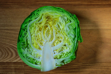 Half fresh young cabbage on a wooden board