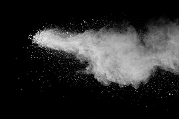Bizarre forms of  white powder explosion cloud against dark background. Launched white particle splash on black background