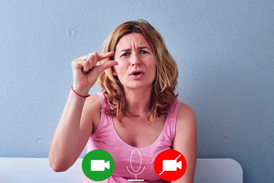 white blonde woman in a video call conversation gesturing comically