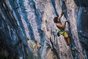 A strong man climbs a rock, Rock climbing in Turkey.