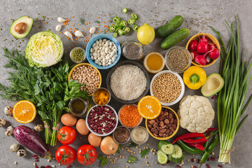 concept balanced diet of fruits, vegetables, seeds, legumes, grains, cereals, herbs and spices. Products containing vitamins, mineral salts, antioxidants, fiber, concrete background.