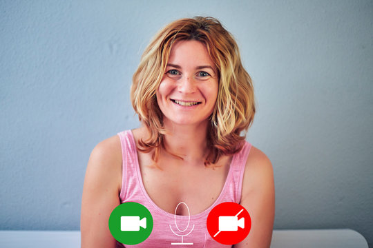 blonde white woman smiling on a video call