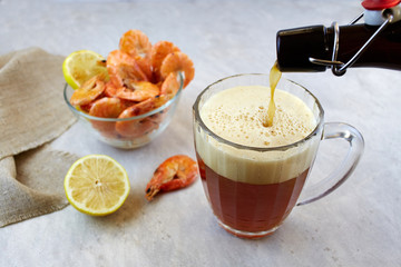 Red irish ale beer with shrimps on light background. Homemade beer.
