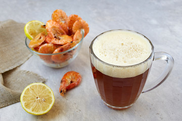 Red irish ale beer with shrimps on light background. Homemade beer.