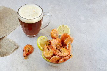 Red irish ale beer with shrimps on light background. Homemade beer.