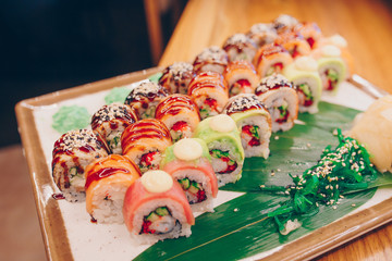 Large set of Sushi Rolls Warm Ebi Sake Unagi Spring. A lot assortment Philadelphia roll Dishes from Japanese raw fish  in one plate in traditional restaurant. Japan food menu service