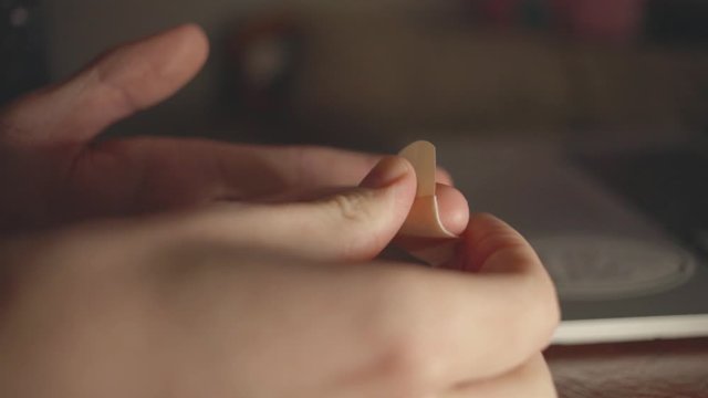Putting Bandage On The Middle Finger - Closeup Shot