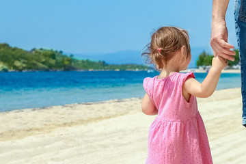 beautiful hands of parent and child by the sea