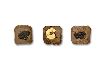 Top view brownie isolated on white background. Oreo and Almond with Currant topping