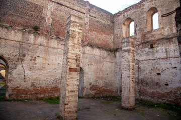 The ruins of an old brick building, ruined walls, Old wall of a ruined red brick house with empty Windows and no roof.