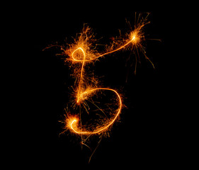 number five written with a sparkler on a black background