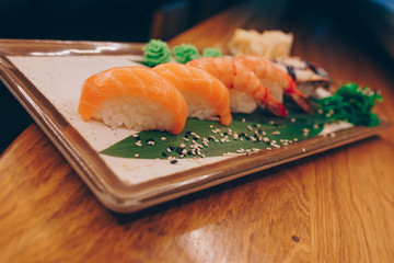 Large set of Sushi Rolls Warm Ebi Sake Unagi Spring. A lot assortment Philadelphia roll Dishes from Japanese raw fish  in one plate in traditional restaurant. Japan food menu service