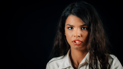 Emotion Arrogance. Arrogant young woman, studio portrait, black background