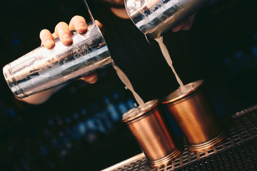 Bartender pouring using strainer White healthy Cocktail drink on a bar counter . Professional view . Trendy stylish alcoholic drink .  Design people and luxury concept service barman in nightclub