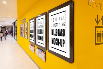 Mock up blank poster in brown frames on yellow wall