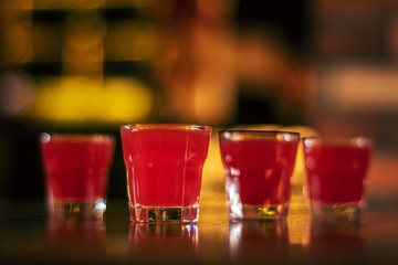 glass of alcohol shots on blurred background